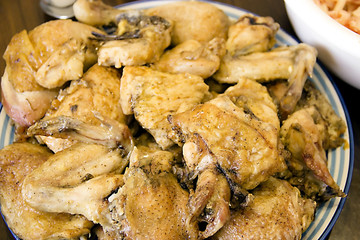 chicken meat is fried in a frying pan