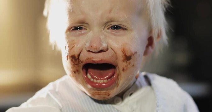Portrait of an upset dirty child.