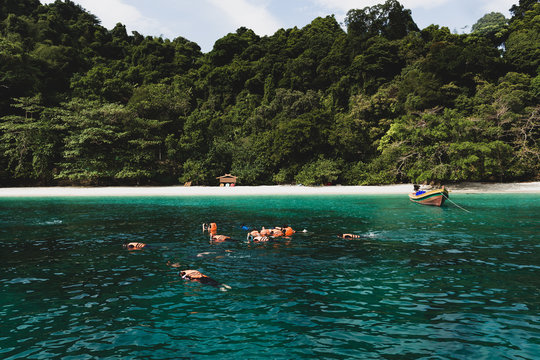 Cinematic color group of tourist doing snorkeling at Flower Island