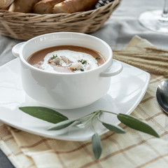 Vegetable cream soup with shrimps in bowl on table