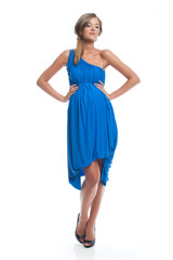 Pregnant attractive slender model in a blue dress on a white isolated background posing. Evening Clothes for pregnant women.