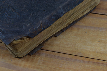 The ancient book (bible) in the leather cover lie on the table