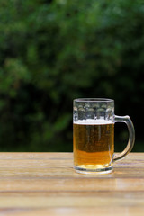 glass of beer on wooden table