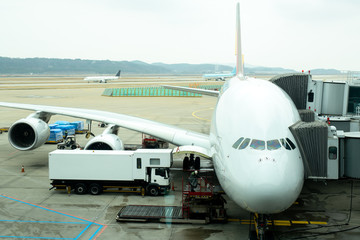Fototapeta na wymiar Front angle view of airplane on gate terminal s