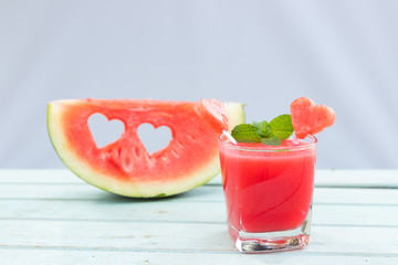 Watermelon juice and slice of delicious ripe watermelon with heart shape