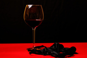 Black underwear and glass of red wine at night
