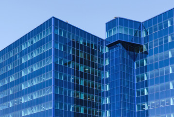 Modern office building made of blue glass.