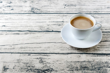 A cup of cofee on a wooden surface