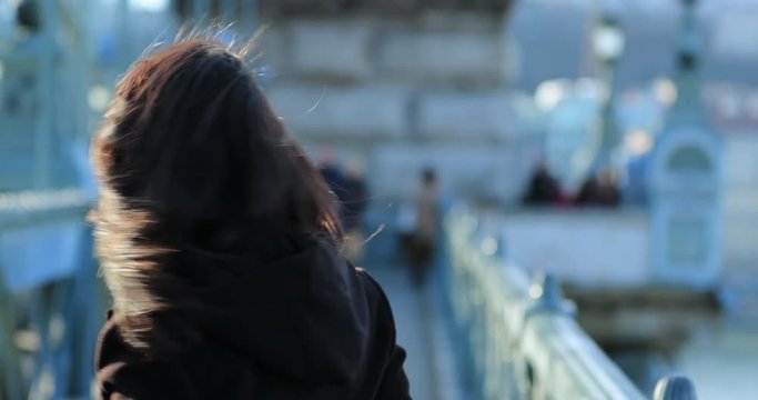 Woman smiling to camera and waving goodbye teasing the viewer. Woman leaving and coming back in 4K