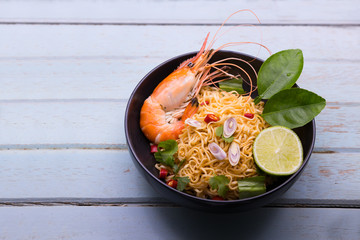 Tom Yum kung Spicy Sour Soup with noodle and ingredient on wooden table , Thai local food