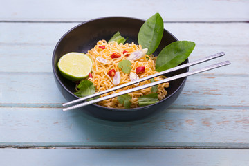 Tom Yum kung Spicy Sour Soup with noodle and ingredient on wooden table , Thai local food