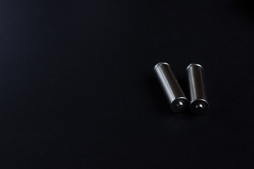 Fuel cells batteries, two AA silver on black background with copy space for text