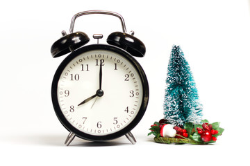 Fototapeta na wymiar Little Christmas tree and vintage clock on white background