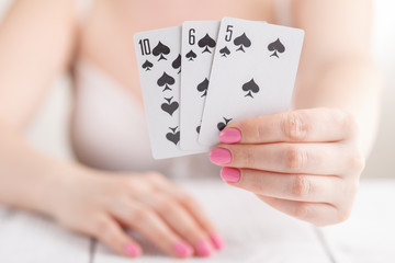 ladies gathered playing black jack cards for money