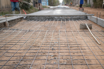 Spreading concrete for sidewalk repair