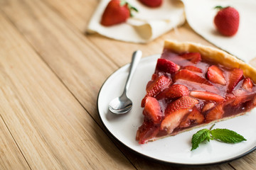 strawberry tart on wooden background.
