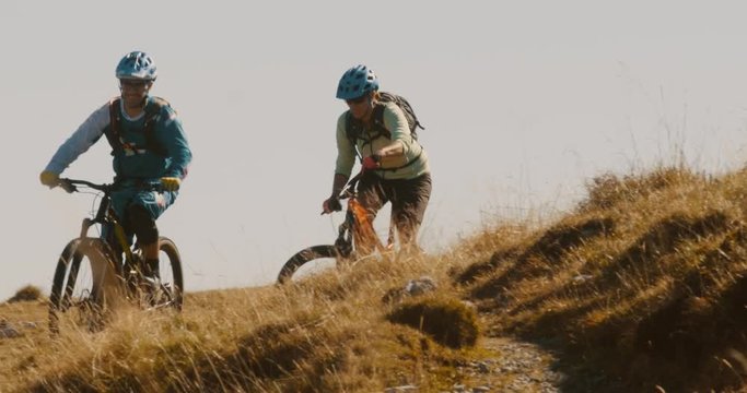Front view  close-up of friends having an adventure on mountain bikes.