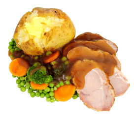 Roast pork and baked potato meal isolated on a white background