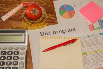 Measure tape and fresh tomato. Healthy lifestyle diet with fresh fruits. Low-calorie fruit diet