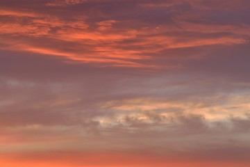 Naklejka na ściany i meble Nature background of vibrant colorful sunset clouds