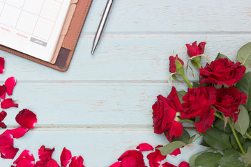 Red roses on wooden board background with copy space