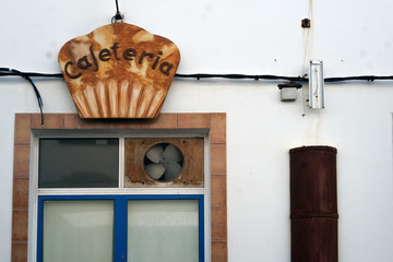 Rusted cafetaria sign in the form of a cup cake.