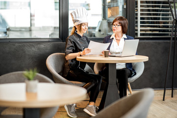 Senior chef and young cook at the restaurant