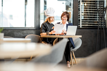 Senior chef and young cook at the restaurant