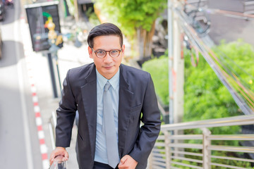 Business man going up the stairs  in a rush hour to work. Hurry time.