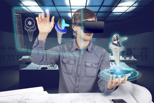 Futuristic Medical Scientist Workplace. Male / Man Wearing Shirt And Vr Glasses Holding Holographic Prosthesis Of Knee And Looking At Virtual Screen Making Medical Analysis On Futuristic Background
