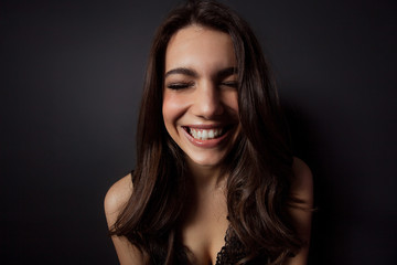 Fototapeta premium Beautiful woman portrait laughing with closed eyes