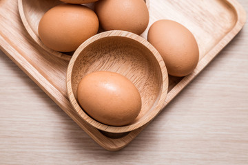 Close-up view of chicken eggs on wooden table background