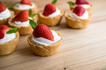Tartlets with strawberries and whipped cream