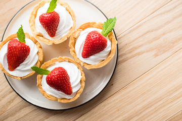 Tartlets with strawberries and whipped cream