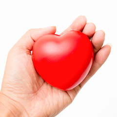 Fototapeta premium Red heart in the hand. Isolated on white background. Studio lighting.