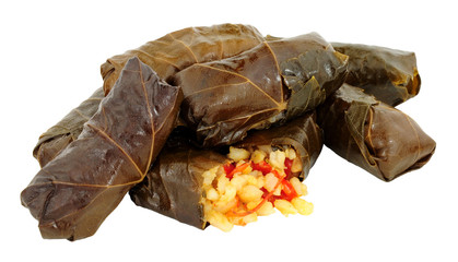 Rice and red pepper filled vine leaves isolated on a white background