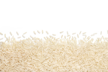 Parboiled rice scattered on white background. Copy space for your text. Top view, high resolution product. Healthy food concept