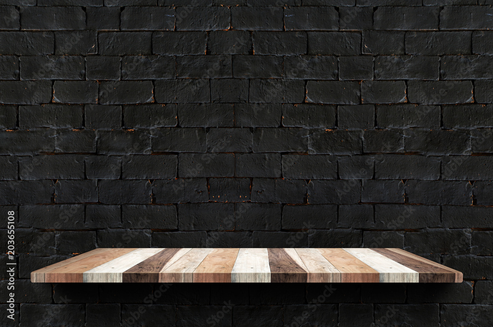 Poster empty wood board shelf at black brick wall background,mock up for display or montage of product or d