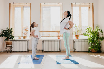 Mom and daughter doing yoga