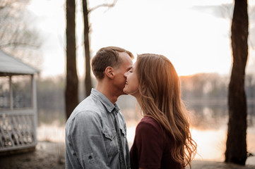 Naklejka premium Couple in love standing face to face on the background of lake