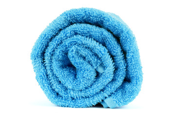 Rolled up blue towel isolated on white