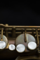 Vintage saxophone on a black background