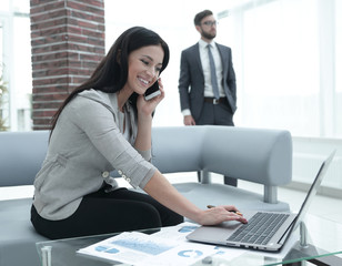 Woman assistant at the workplace in the office