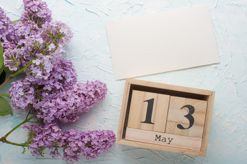 Gray on a light background with a calendar on May 13, International Mother's Day. Top view with empty space for labeling or advertising © Anton