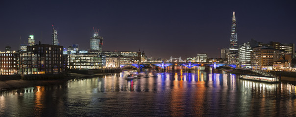 Fototapeta na wymiar Beautiful London City skyline landscape at night with glowing city lights and iconic landmark buldings and locations