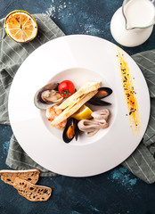 cheese soup with seafood, mussels, squid, shrimps and white bread toast - 203660793