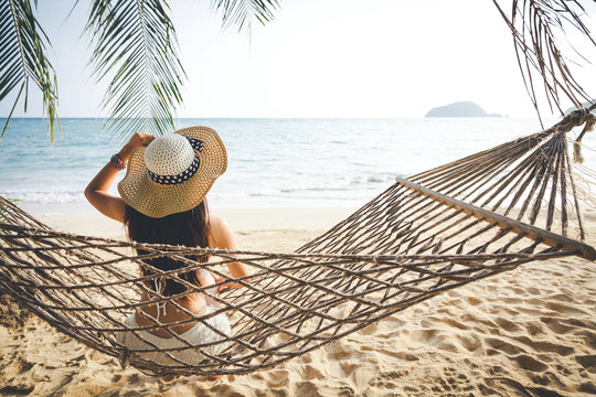 Happy woman relaxing in hammock