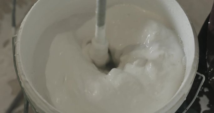 stirring putty in the bucket