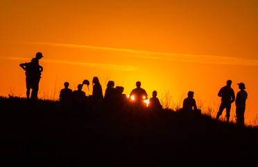 Fototapeta na wymiar People silhouettes on sunset