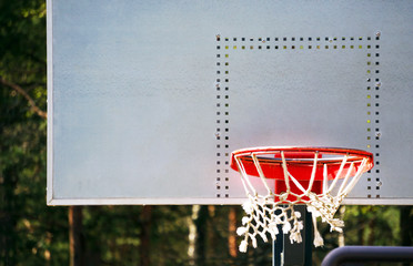 Fototapeta na wymiar outside basketball court. Grey background. Sport in nature.